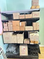 Full view of shelf loaded with cardboard cases and plastic crate