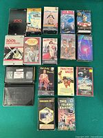 Overall lot showing sixteen VHS tapes with visible titles and box types