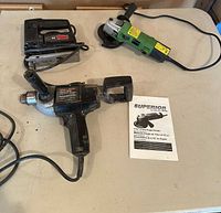 All three corded tools and Superior grinder manual on table