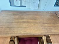 Top view of oak desk surface showing wood grain and wear