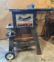 Full view of Craftsman table saw on stand with wheel visible