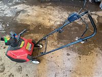 Side view of Toro 1500 Power Curve snow thrower showing overall condition and handle assembly