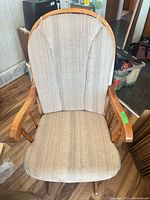 Front view of wood glider chair showing full structure and upholstery