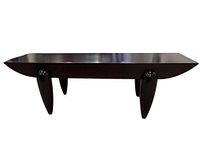 Full front view of sculptural dark brown wooden bench/coffee table