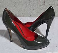 Side view of both pumps showing exterior color, heel height and platform