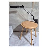 Full view of black clamp desk lamp on stool showing entire structure