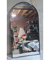 Front view of arched mirror reflecting room