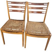 Front view of both teak chairs showing damaged rattan seats and slatted backs