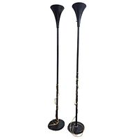 pair of black metal trumpet torchiere lamps standing side by side