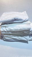 Stack of folded white pillow covers