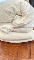 Folded white cotton sheets showing fabric and color