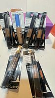 Front view showing all eight sealed CoverGirl concealer packs