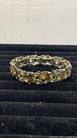 Full view of silver-tone bracelet with yellow crystals