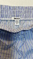 DKNY fabric tag showing brand and size S/P on striped waistband