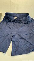 Front view of navy blue shorts showing full garment and pockets
