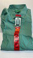 Folded green and white striped dress shirt showing collar and tags