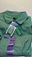 Folded green and white striped Benetton dress shirt with tags visible