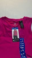 Front view of pink Spyder tank top with attached tag showing size L/G