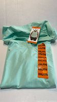 Folded mint green HEAD sleeveless top with size sticker