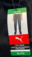 Retail hang tag showing size XL/TG and product name Boys Jogger
