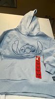 Front view of light blue hoodie with Stitch outline graphic