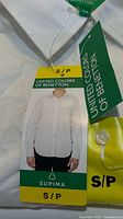 Front view of folded white dress shirt with tags
