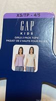 Front of retail insert showing Gap Kids girls 2-pack tops size XS 4/5