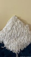 Front view of off-white shaggy square pillow