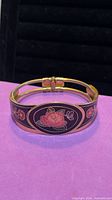 Front view of brass enamel bangle showing floral design