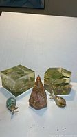 Group shot of all five items: two lucite blocks, one lucite pyramid, two glass fish
