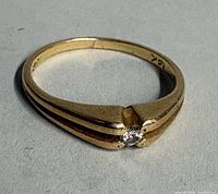 Full view of gold ring with diamond accent