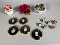 Group shot showing all ceramic flowers, place card holders and cameo plaques