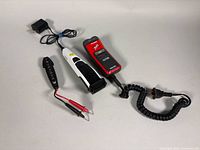 Group shot of shaver, trimmer, circuit breaker, and power adapter with cables visible