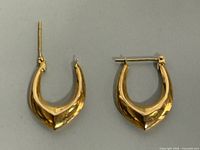 Front view of both yellow gold drop earrings showing overall shape and finish