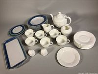 Full grouping of porcelain pieces including teapot, cups, bowls, plates and platters