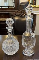 Both decanters front view showing overall shape and stoppers