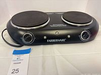 Front view of Farberware double burner cooktop showing both burners, control knobs and power cord