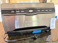 Front view of FoodSaver vacuum sealer showing controls and finish