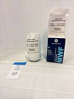 Filter cartridge, damaged box, and lot tag visible