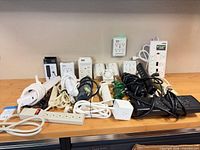 Group shot of all power strips, adapters and timers on workbench