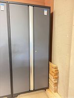 Front view of closed gray metal cabinet