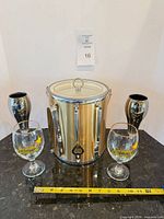 Front view of entire lot: ice bucket, two Corsendonk goblets, two mirrored flutes