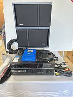 Front view of Yamaha receiver with Bose speakers and cables