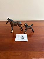 Adult horse and foal Beswick figurines side by side on tabletop