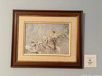 Framed Robert Bateman Winter Lady print on wall with lot tag visible