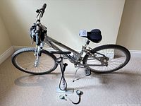 Side view of Giant Sedona LX bicycle with handlebar bag, gel saddle, kickstand, and Blackburn floor pump with adapters positioned below