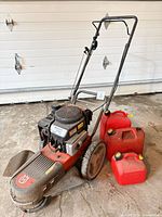 Full view of trimmer and three jerry cans