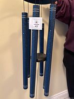 Close view of hanging tubes showing color, finish, and MaxSold tag