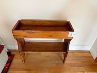 Front view of the pine planter box showing trough and lower shelf