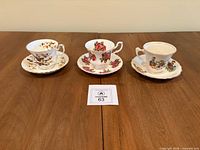Three teacup and saucer sets on table